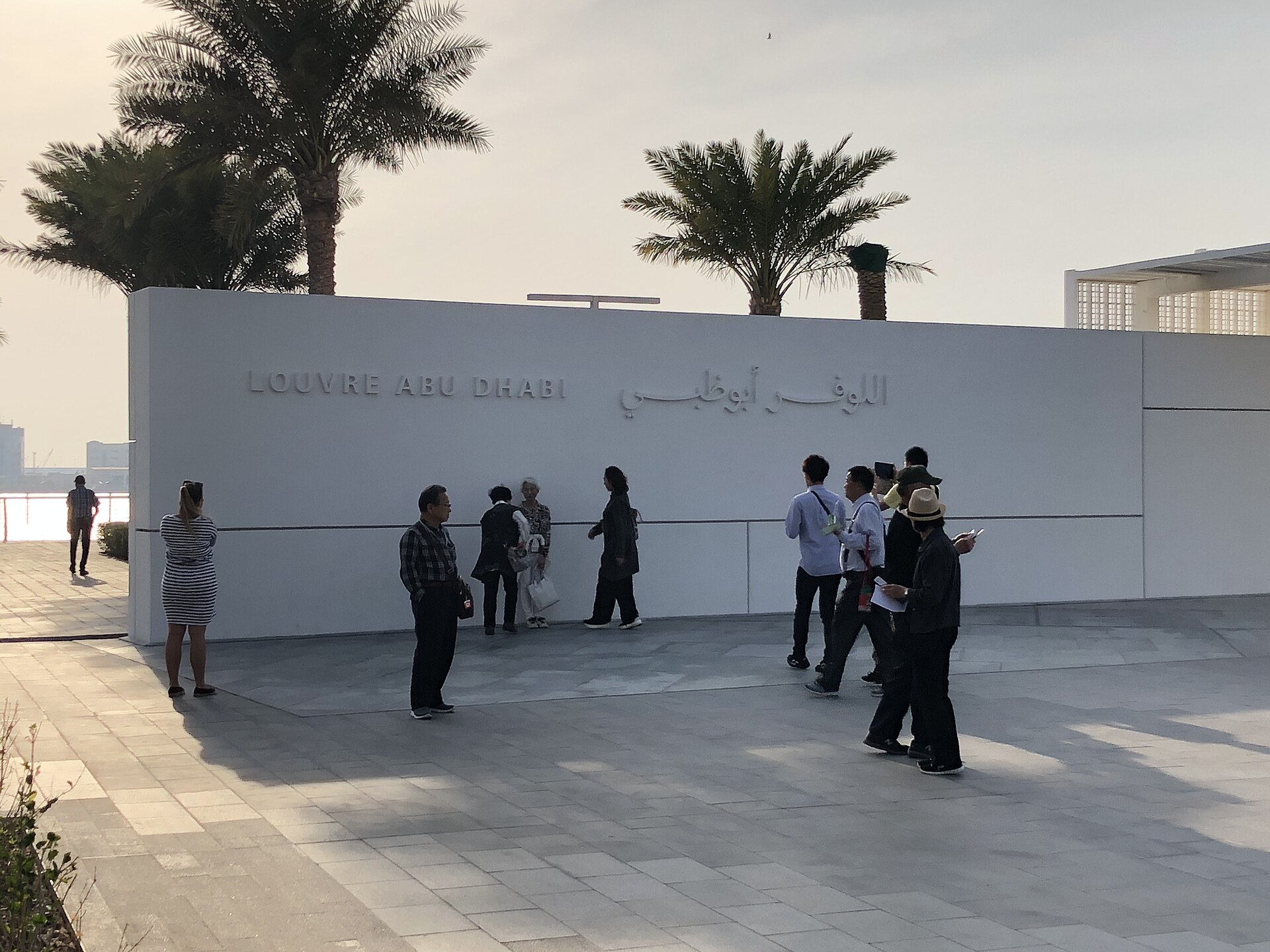The latticed dome of the Louvre Abu Dhabi over the water